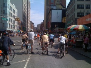 Cyclists wait sanguinely at stop light.