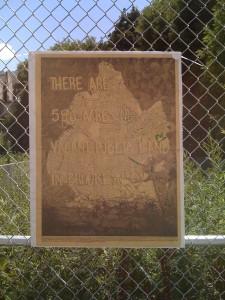 A 596 Acres poster graces the fence of a vacant lot in Gowanus.