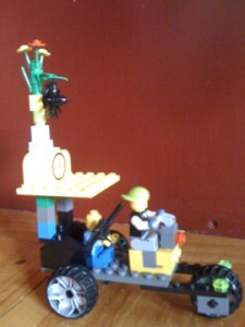 Lego rendering of a pedicab ride, post-collapse - note the crude design of the home-grown vehicle, and the passenger's assertion of his right to bear arms. 